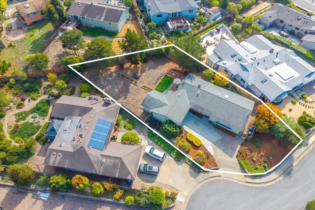 an aerial view of residential building and trees around