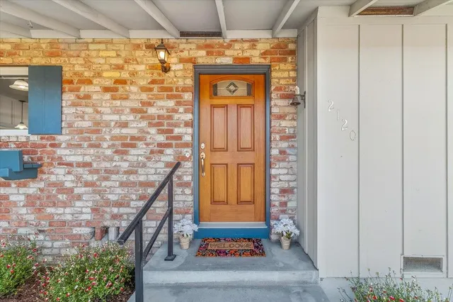 a vase of flowers sitting on a shelf