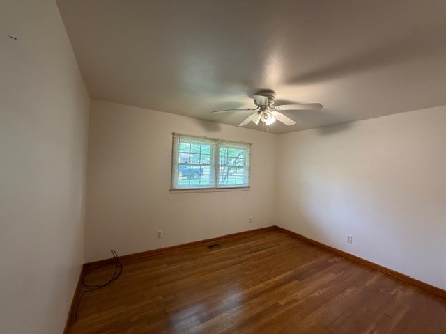 12 Perkins Road Fayetteville, TN 37334 - Photo 18 of 25 an empty room with wooden floor chandelier fan and windows