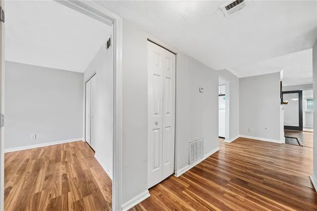 a view of a room with wooden floor and bathroom