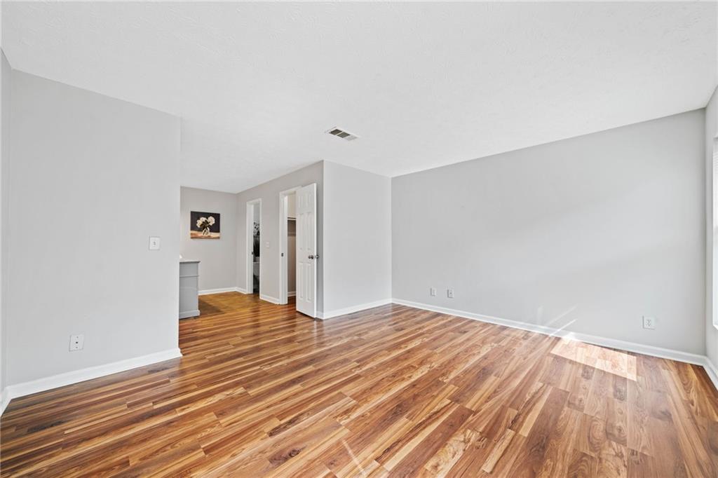 717 Beaufort Circle Duluth, GA 30096 - Photo 14 of 42 a view of an empty room with wooden floor