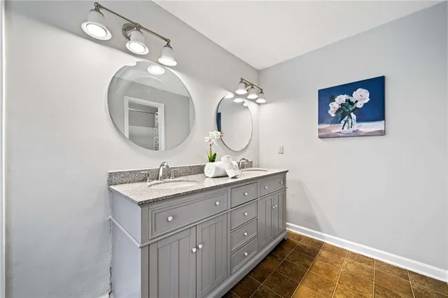 a bathroom with a double vanity sink and a mirror