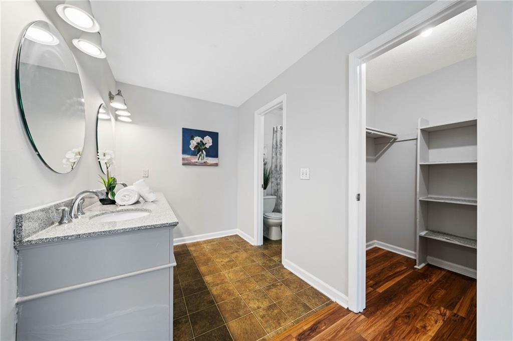 717 Beaufort Circle Duluth, GA 30096 - Photo 17 of 42 a en suite bathroom with a double vanity sink and a mirror