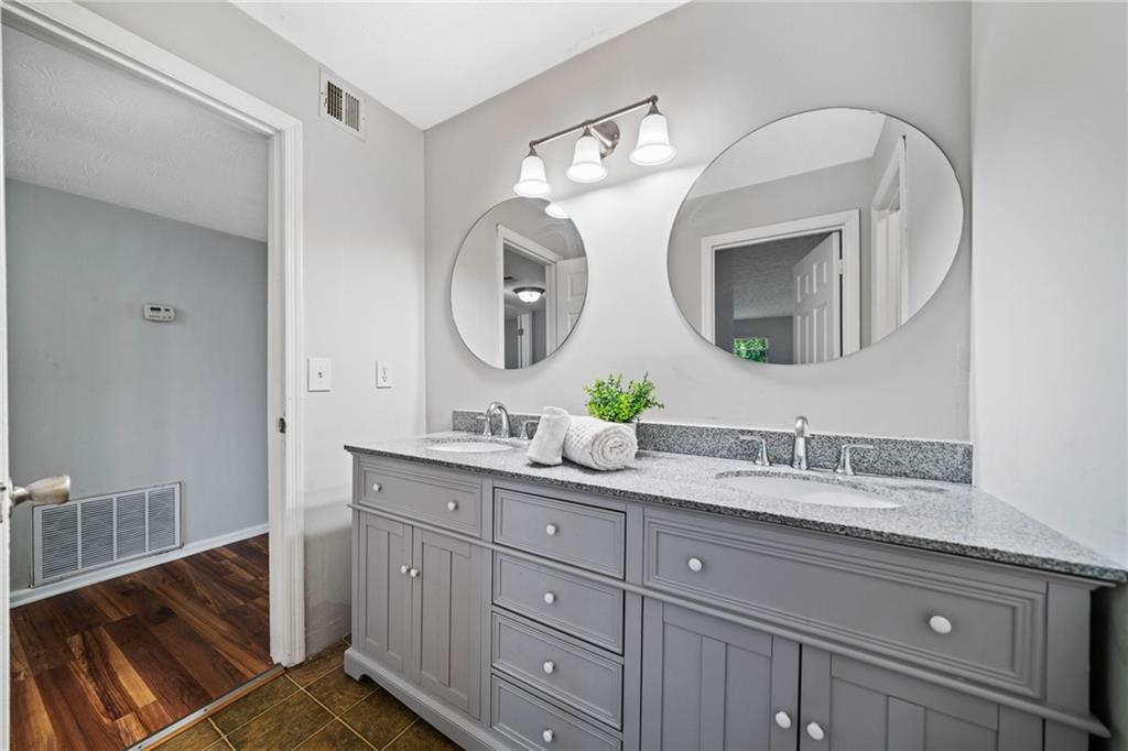 717 Beaufort Circle Duluth, GA 30096 - Photo 8 of 42 a bathroom with a double vanity sink and a mirror
