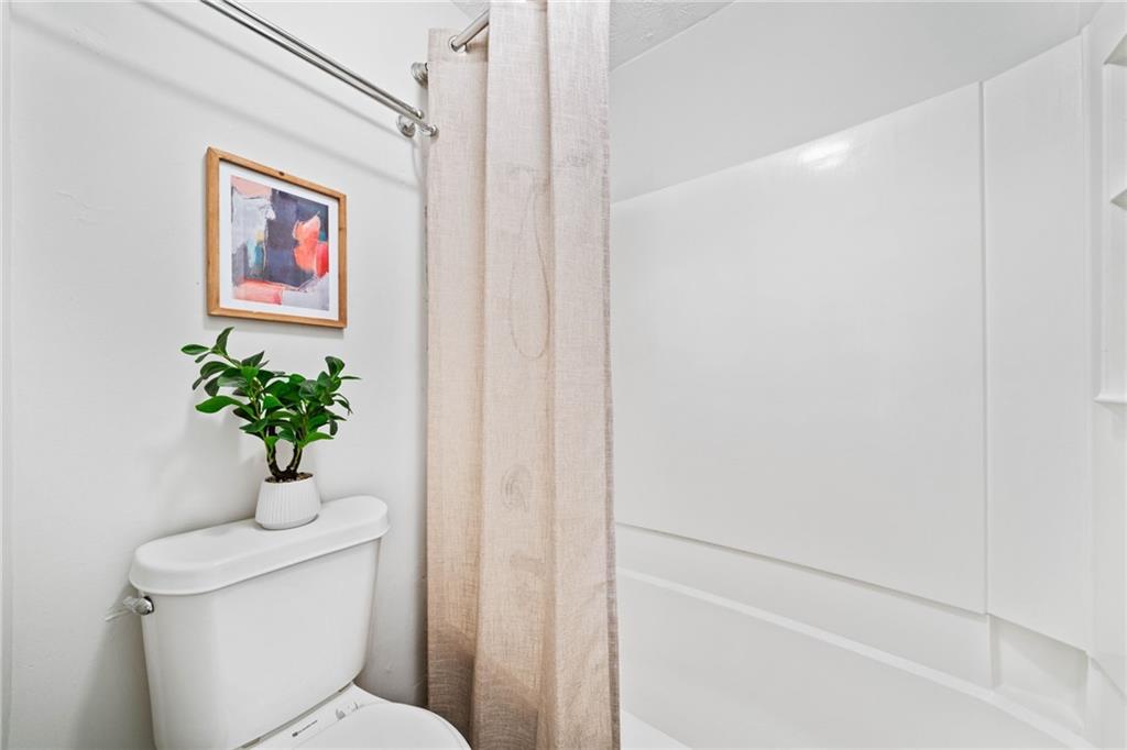 717 Beaufort Circle Duluth, GA 30096 - Photo 10 of 42 a bathroom with a shower a toilet and a window