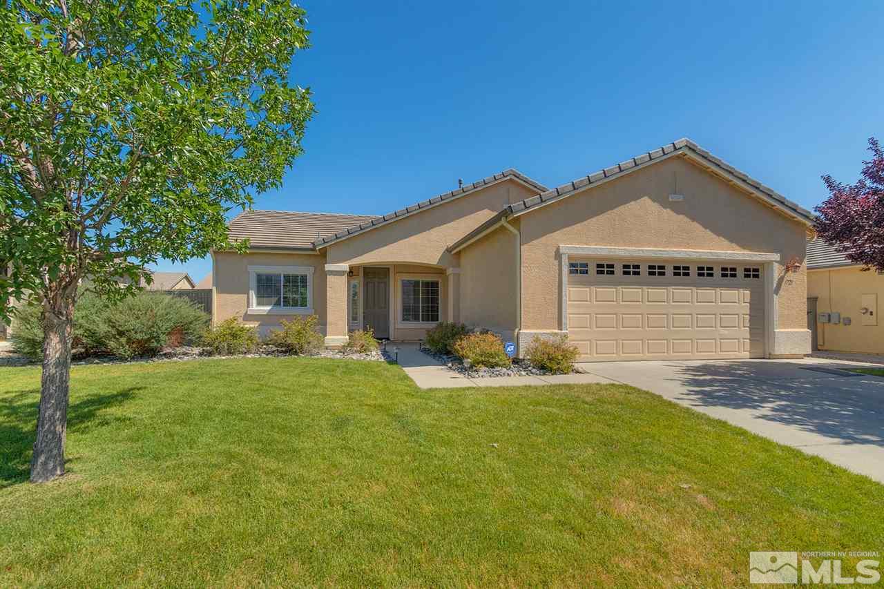 1721 Camaraderie Way Reno, NV 89521 - Photo 1 of 18 a front view of a house with a garden and yard
