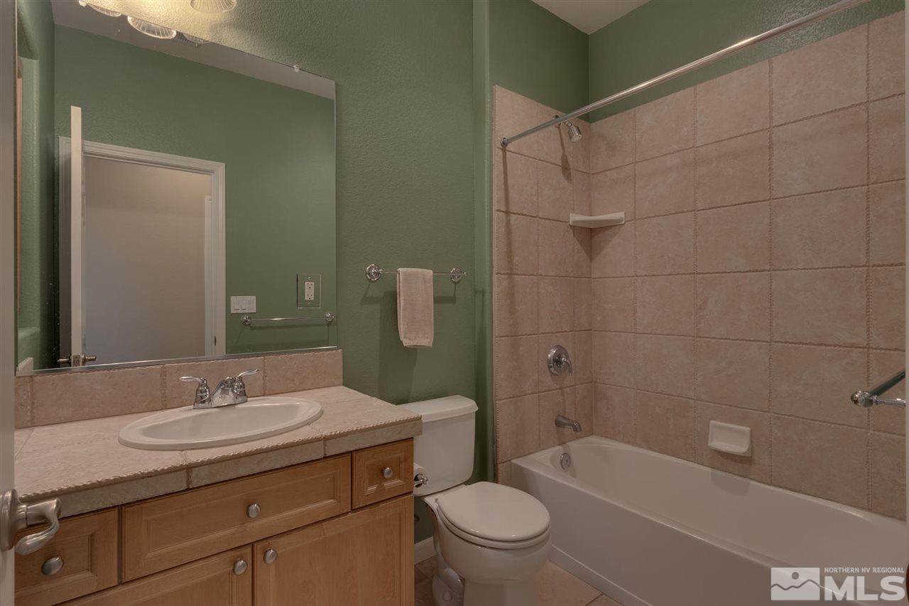 1721 Camaraderie Way Reno, NV 89521 - Photo 17 of 18 a bathroom with a granite countertop sink toilet and shower