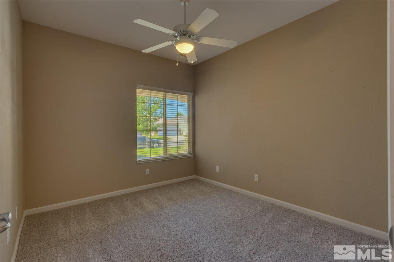 1721 Camaraderie Way Reno, NV 89521 - Photo 18 of 18 an empty room with a window and a fan