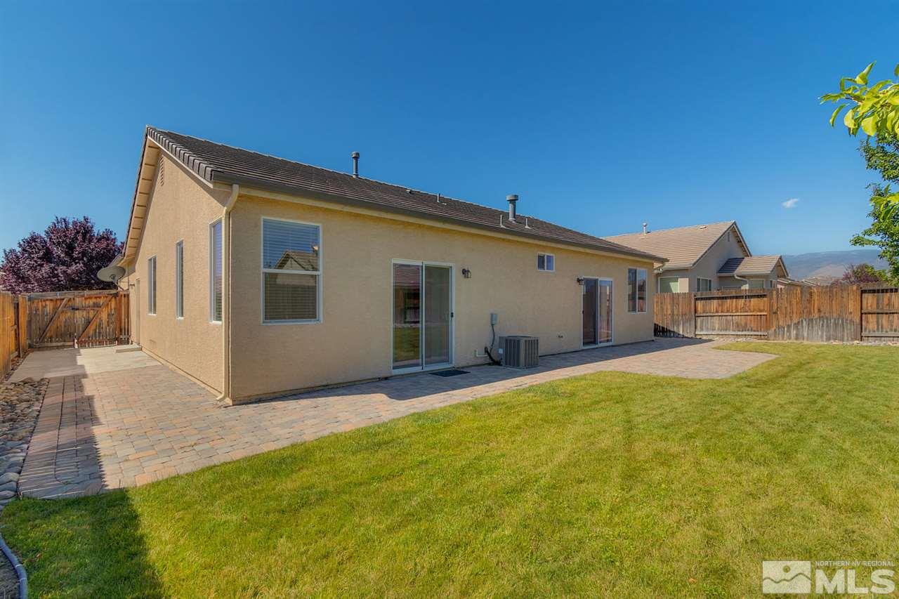 1721 Camaraderie Way Reno, NV 89521 - Photo 4 of 18 a front view of house with yard and trees in the background