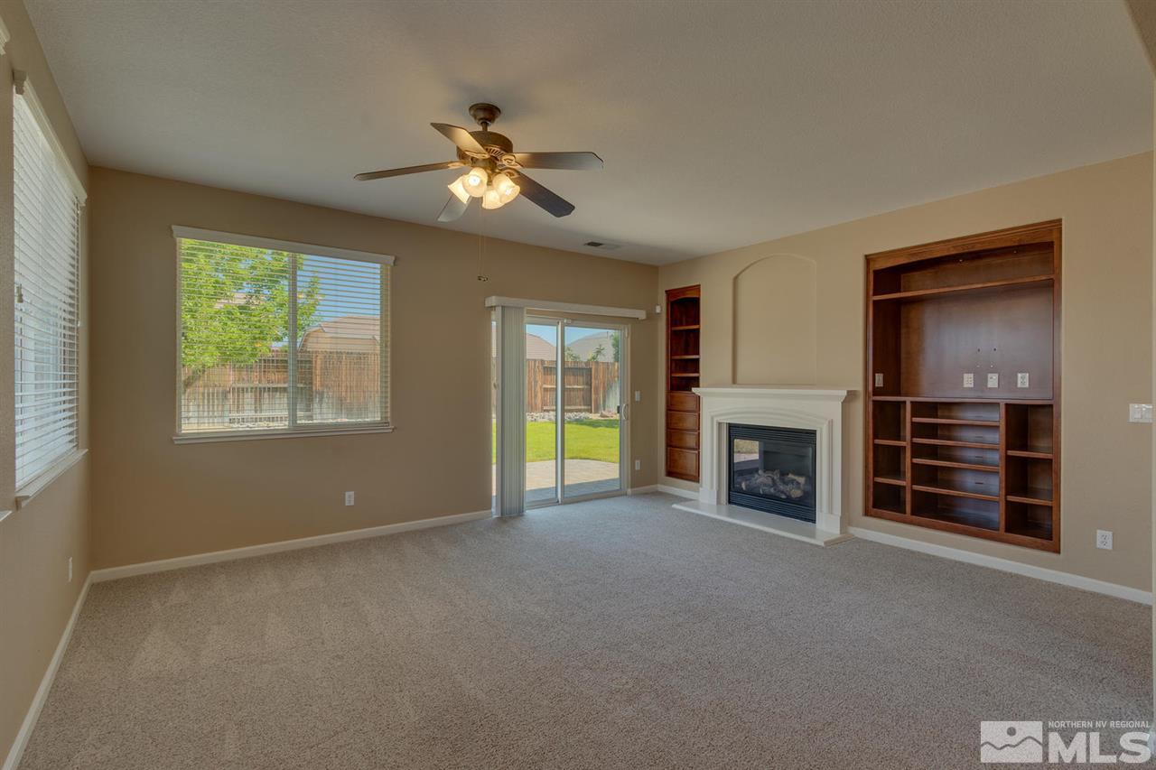 1721 Camaraderie Way Reno, NV 89521 - Photo 5 of 18 a view of an empty room with a fireplace and a window