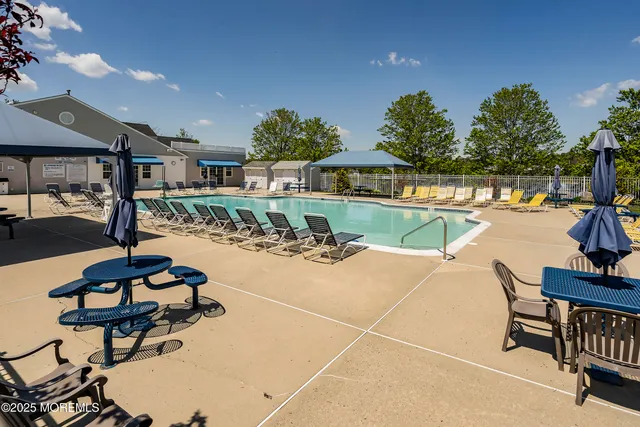 a view of a swimming pool and lounge chairs
