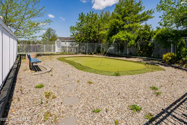 a view of a swimming pool with a patio and a yard