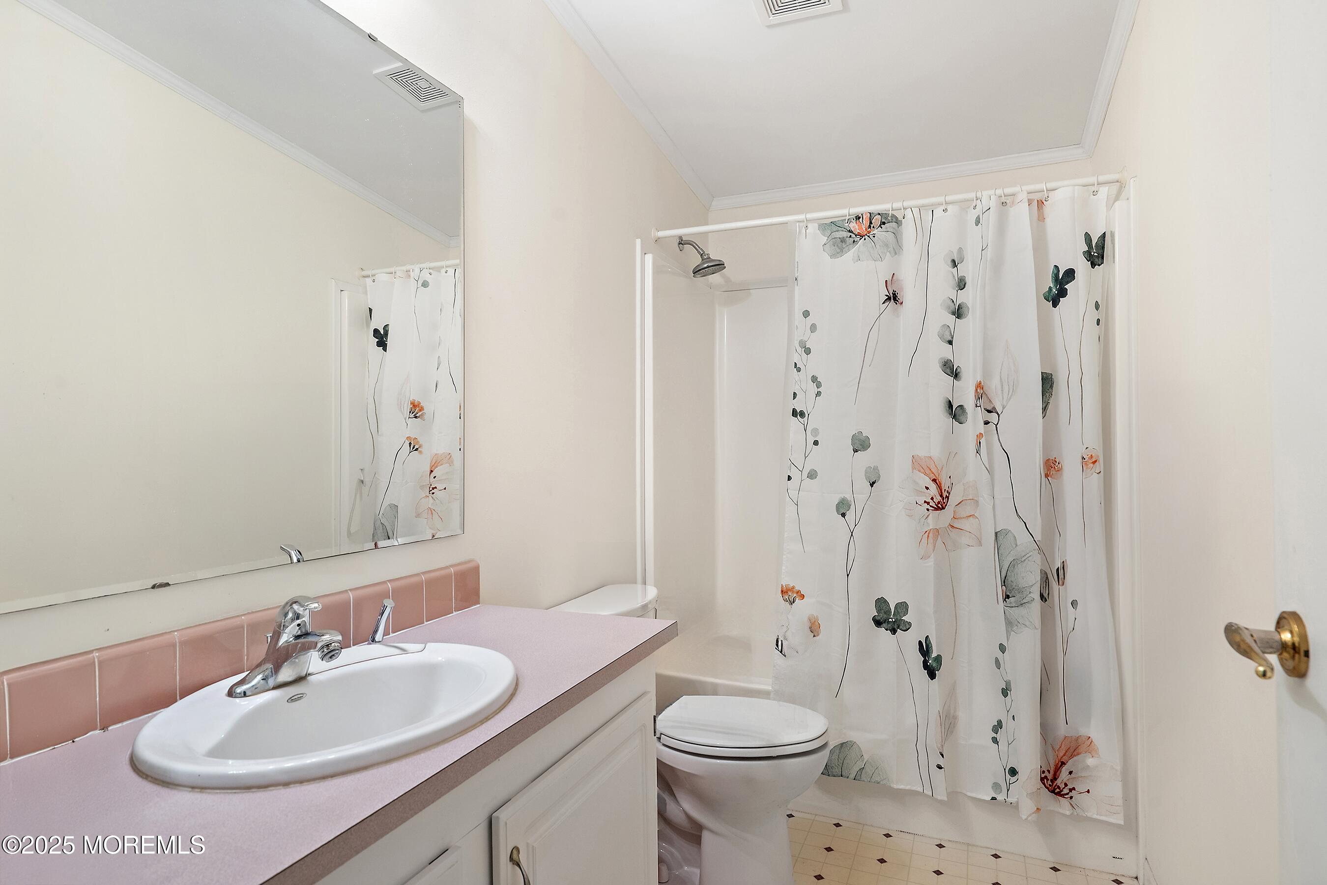 75 Perrys Lane Manahawkin, NJ 08050 - Photo 10 of 18 a bathroom with a sink toilet a shower and a mirror
