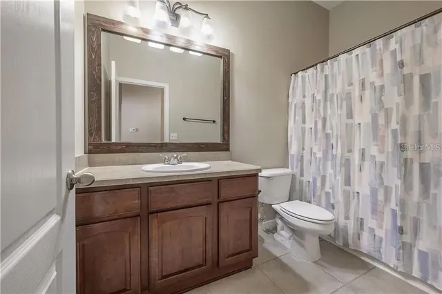 a bathroom with a sink a toilet and mirror