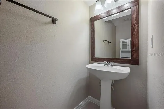 a bathroom with a sink and mirror