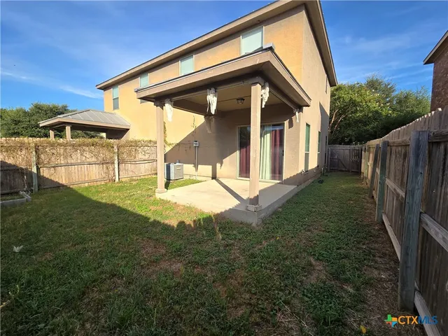a view of backyard with a garden and deck