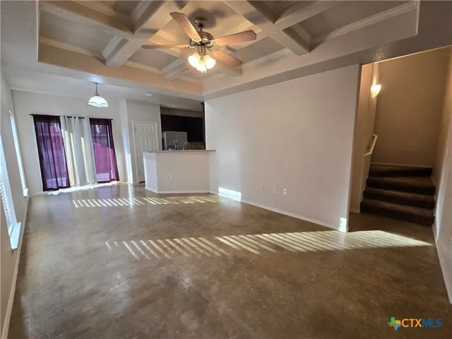 a view of a livingroom with furniture and a ceiling fan