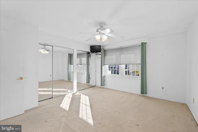 a spacious bedroom with a bed and a chandelier