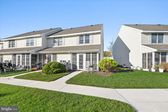 a front view of a building with a garden