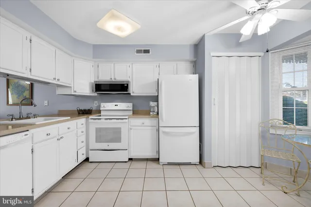 a kitchen with cabinets and window