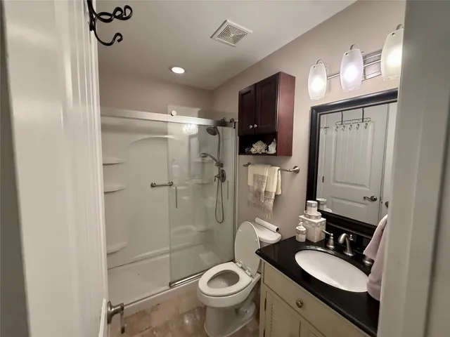 a bathroom with a sink toilet mirror and shower