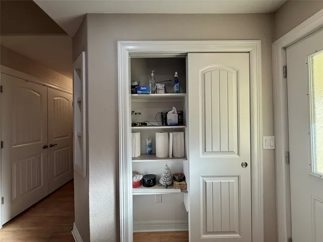 a view of kitchen and bathroom with wooden floor