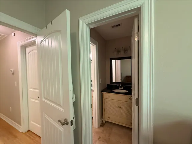 a view of a bathroom from a hallway