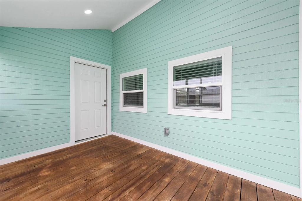 4955 Old Lucerne Park Road Winter Haven, FL 33881 - Photo 13 of 17 a view of an empty room with wooden floor and a window