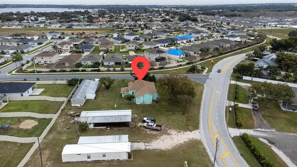 an aerial view of a houses with yard