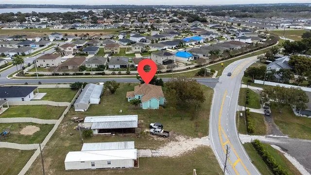 an aerial view of a houses with yard