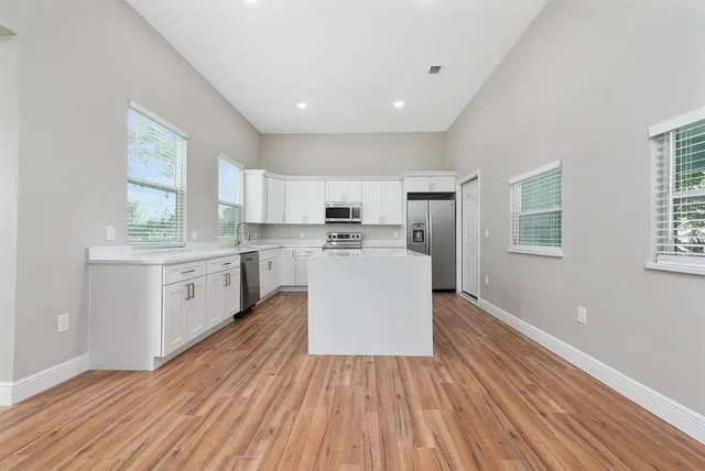 a kitchen with wooden floors and white appliances