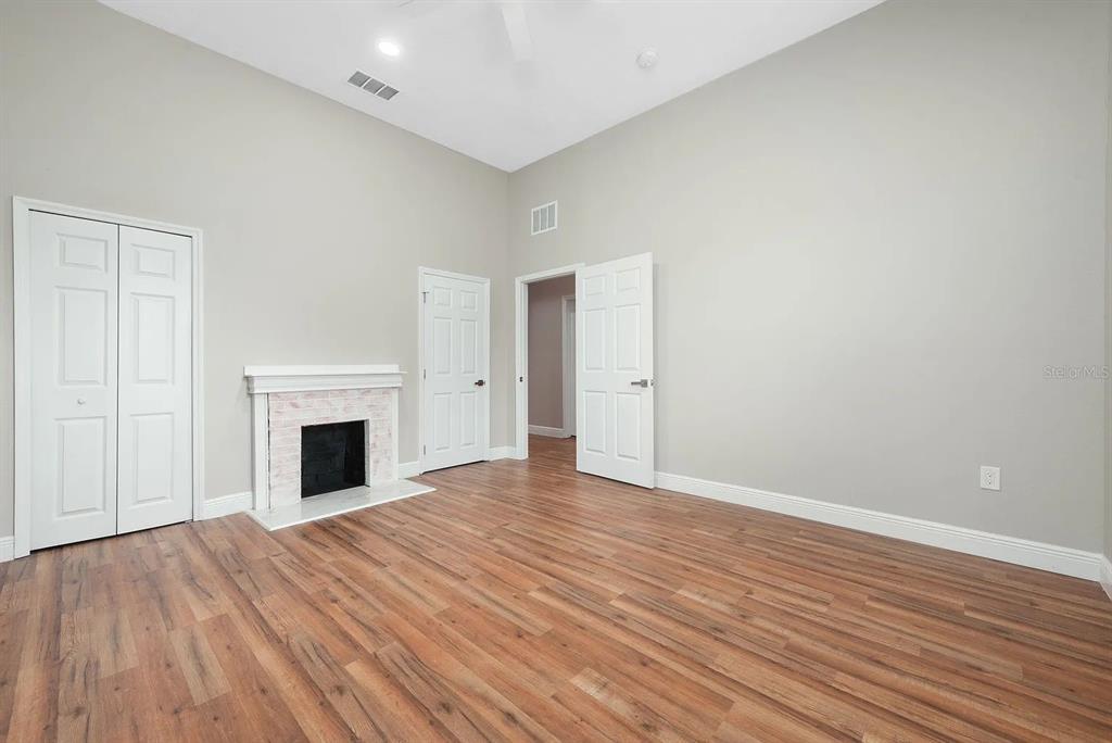 4955 Old Lucerne Park Road Winter Haven, FL 33881 - Photo 10 of 17 a view of empty room with wooden floor and fireplace