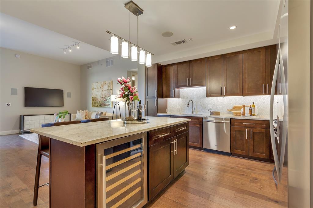 4719 Cole Avenue, Unit 358 Dallas, TX 75205 - Photo 4 of 35 a kitchen with a stove a sink and a refrigerator