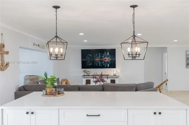 a living room with furniture and a view of kitchen