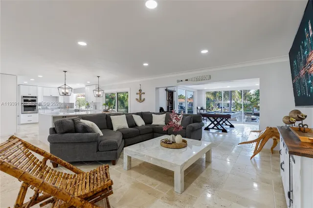 a living room with furniture a rug and a large window