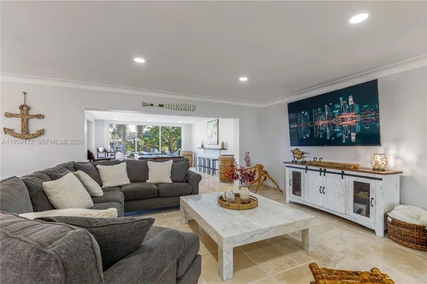 a living room with furniture pool table and a large window