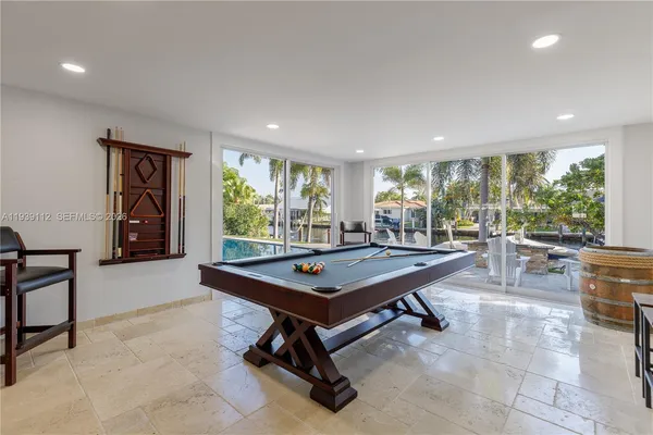 a living room with furniture kitchen view and a flat screen tv