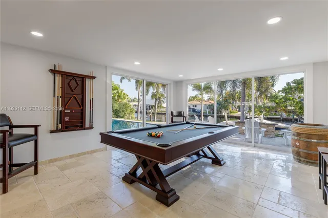 a living room with furniture kitchen view and a flat screen tv