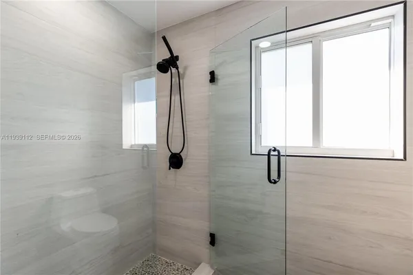 a bathroom with a double vanity sink a mirror and a toilet