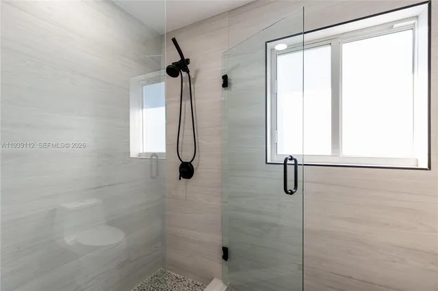 a bedroom with a bed and a mirror