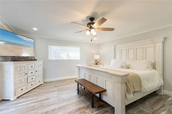 a bedroom with a bed and a mirror