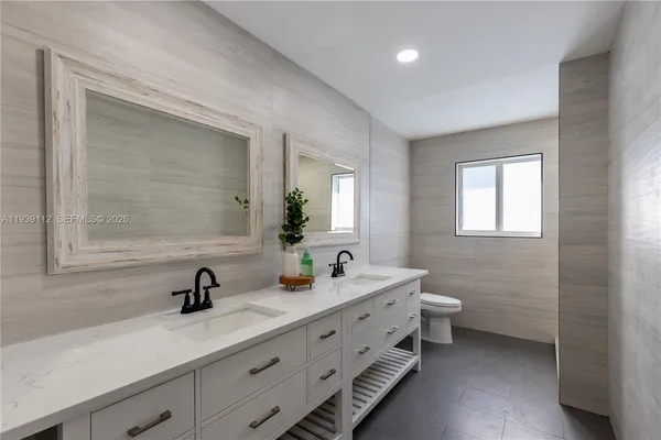 a bedroom with a bed and a night stand