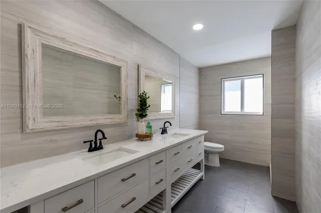 a bedroom with a large bed and a large window