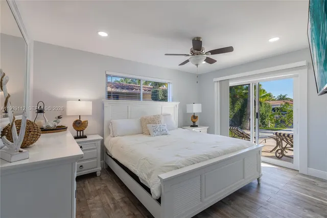 aerial view of a house with swimming pool and lawn chairs under an umbrella