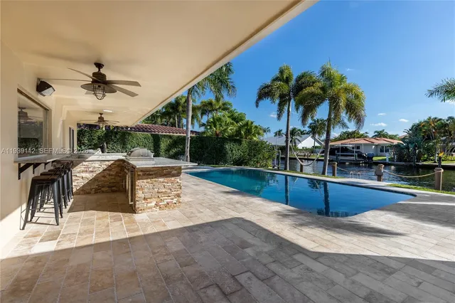 a view of a house with swimming pool and sitting area