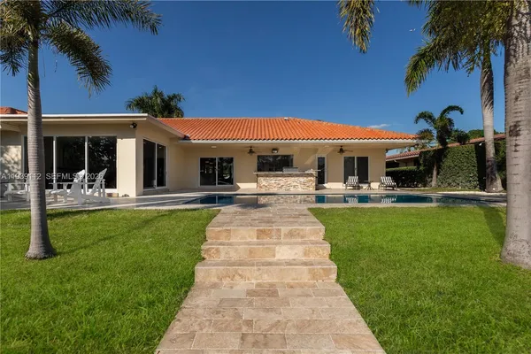 a swimming pool with outdoor seating and yard