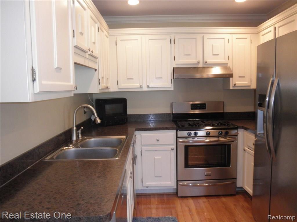 1389 Paddle Wheel Lane Rochester, MI 48306 - Photo 3 of 32 Bright Kitchen with newer stainless appliances, counter, and hardwood flooring