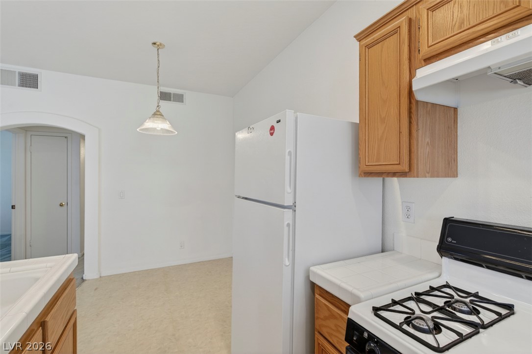 2201 Ramsgate Drive, Unit 1011 Henderson, NV 89074 - Photo 14 of 40 Functional kitchen with traditional cabinetry and essential appliances awaits your personal touch.