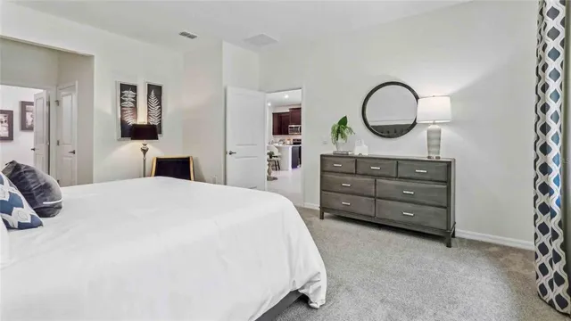 a bedroom with a bed and a dresser