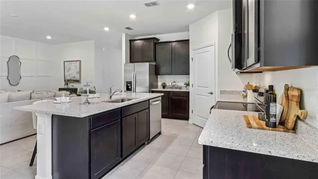a kitchen with a sink and a refrigerator